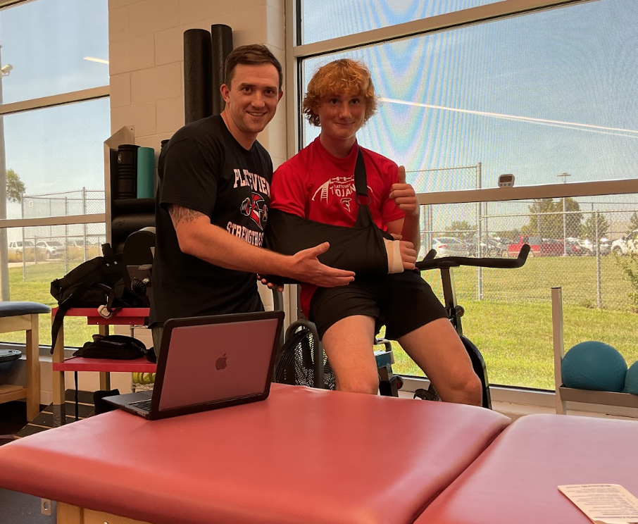 Robert Dill and Landon Nelson (9) pose for a photo after finishing their rehabilitation session.